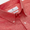 View 2 of product The Turnbull & Asser Pink Linen Weekend Fit Hayne Shirt is a casual, long-sleeve button-down with a subtle texture and white buttons, neatly laid flat on a white background.