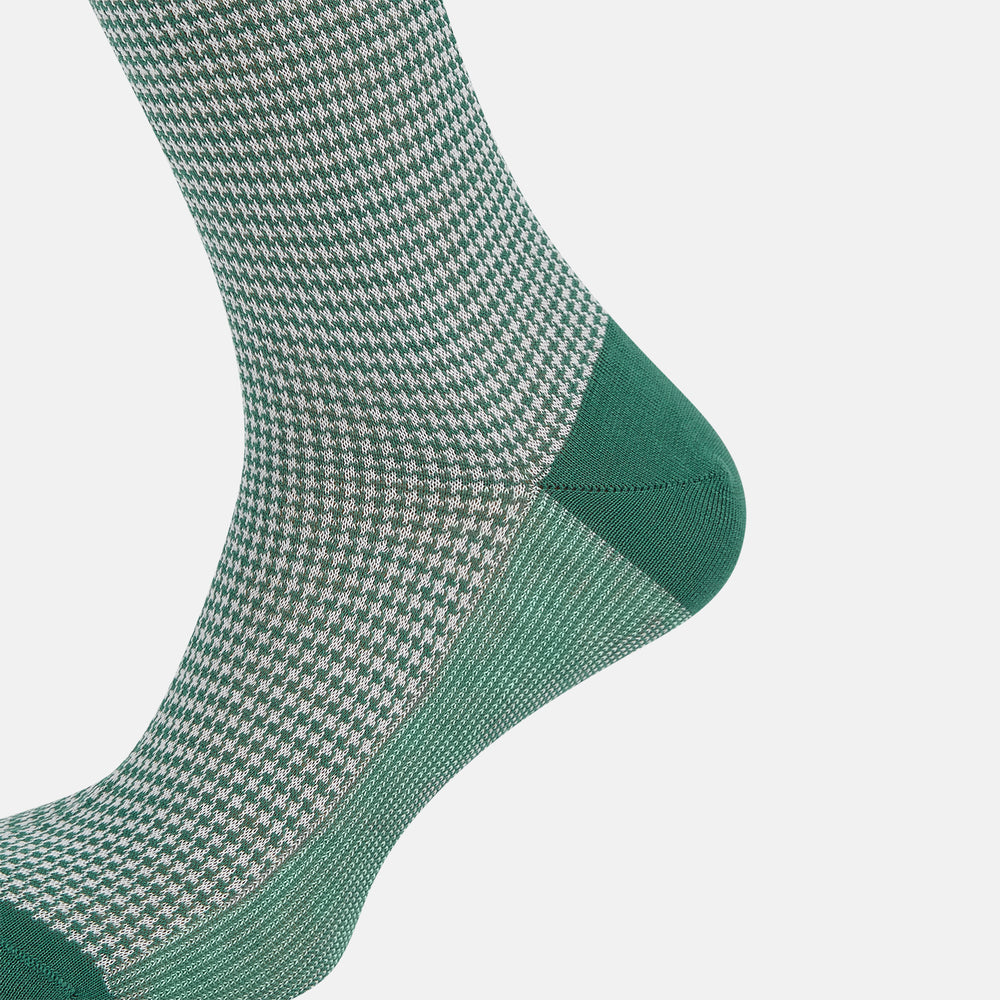 The Ivory/green Houndstooth Long Sock by Turnbull & Asser features a houndstooth pattern on the lower half with a solid green upper band, heel, and toe, shown against a white background.