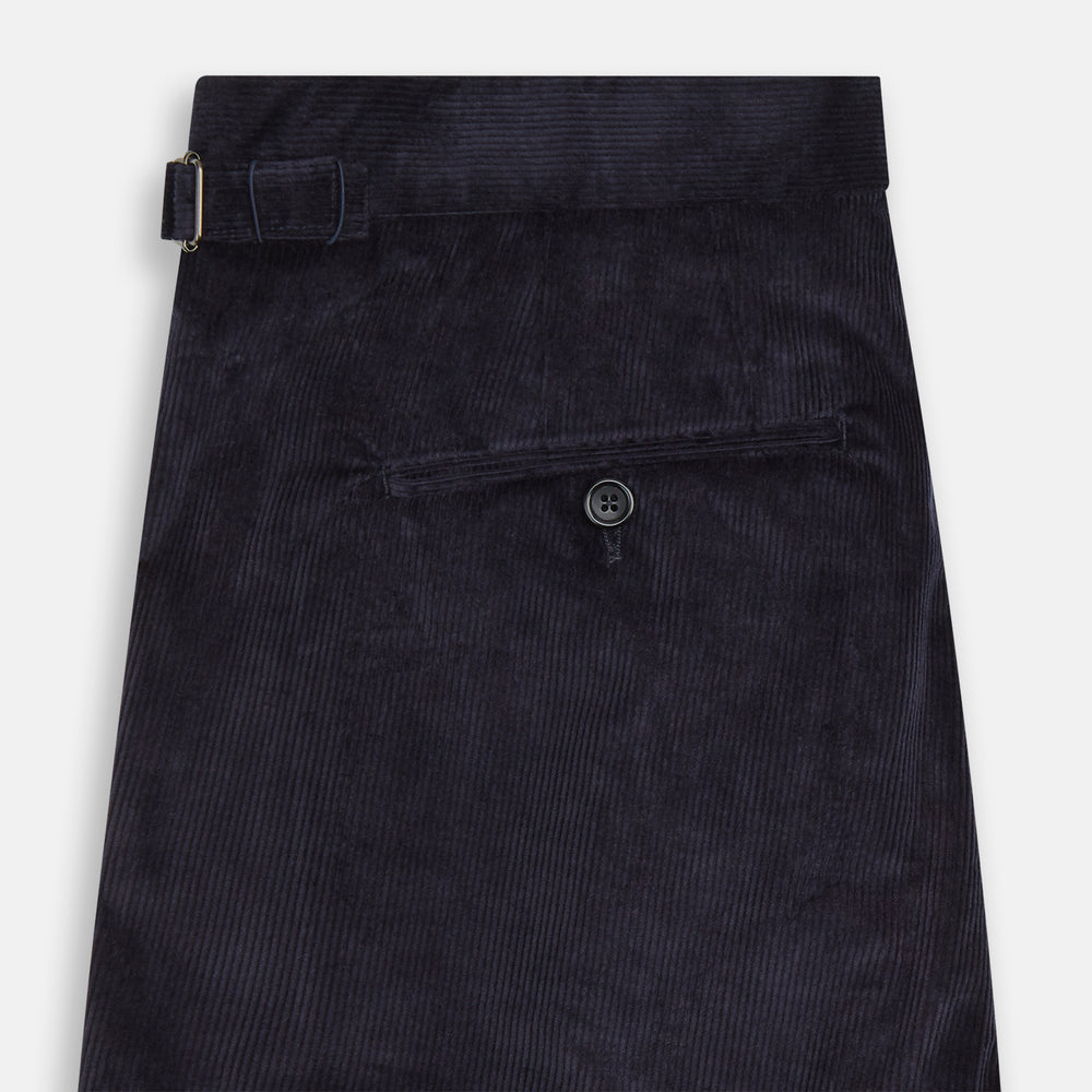 The Turnbull & Asser Navy Corduroy Henry Trousers are tailored fit with a straight-leg cut, made from a wool-cotton blend, and feature front button and zip closure, shown against a plain white background.