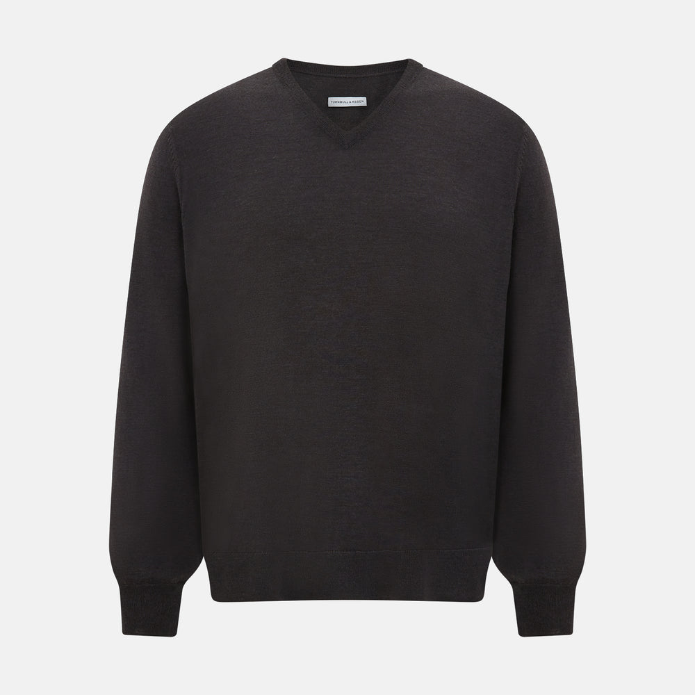 The Turnbull & Asser Charcoal Grey Merino V Neck Jumper is a classic long-sleeve knit with ribbed cuffs and hem, featured in our knitwear collection and shown against a white background.