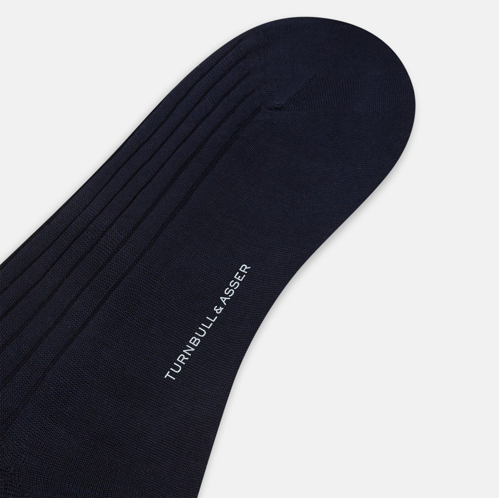 A single, navy mid-length sock by Turnbull & Asser is displayed upright on a plain white background.