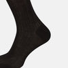 View 4 of product A single Black Cotton Mid-Length Sock by Turnbull & Asser, featuring a ribbed texture and crafted from premium Egyptian cotton, is displayed upright against a plain white background.