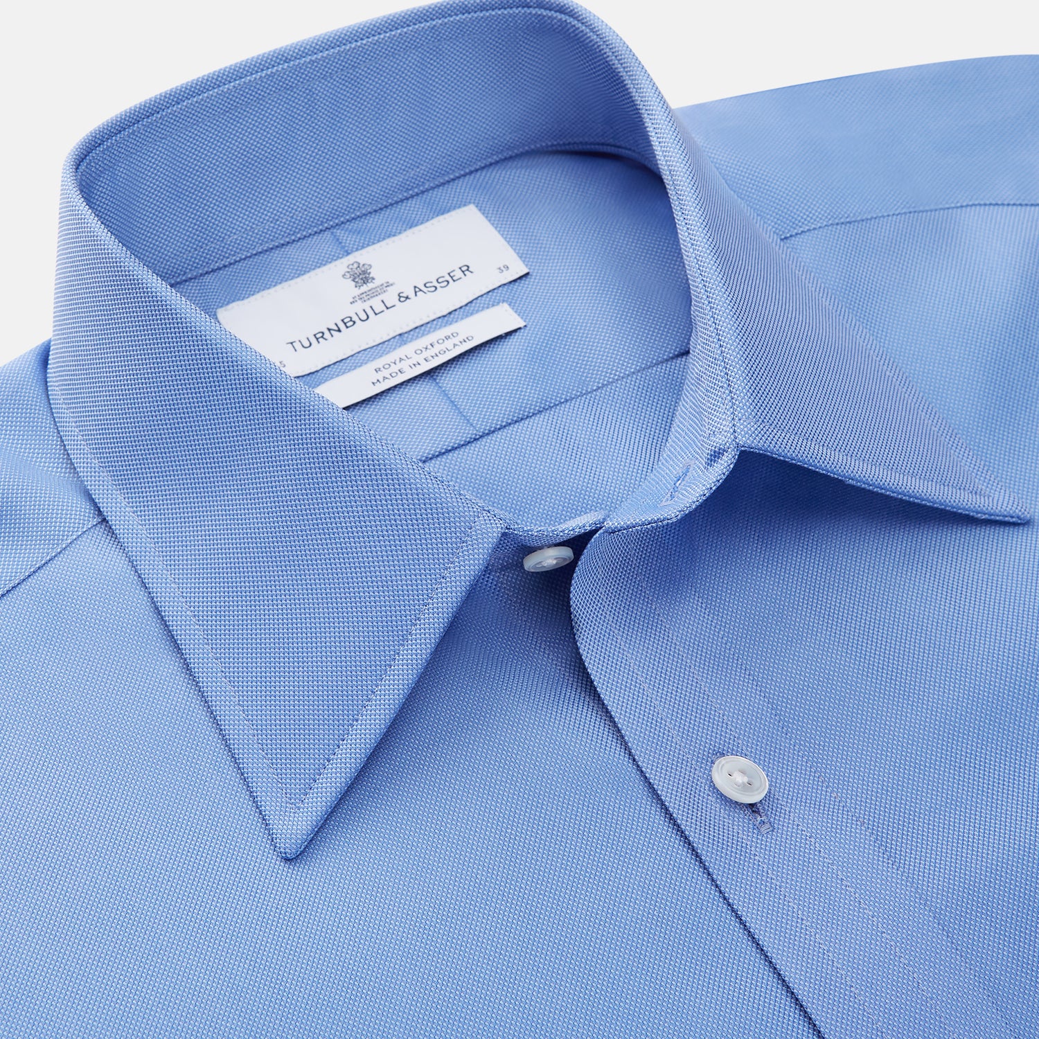 View 2 of product The World Is Not Enough Blue Cotton Istanbul Shirt by Turnbull & Asser, as seen on James Bond, features long sleeves, white buttons, a classic collar, and buttoned cuffs, shown against a plain white background.
