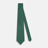 View 2 of product The Forest Green Geometric Floral Printed Silk Tie by Turnbull & Asser is shown rolled up on a white background, its English silk material featuring an elegant green and turquoise pattern.