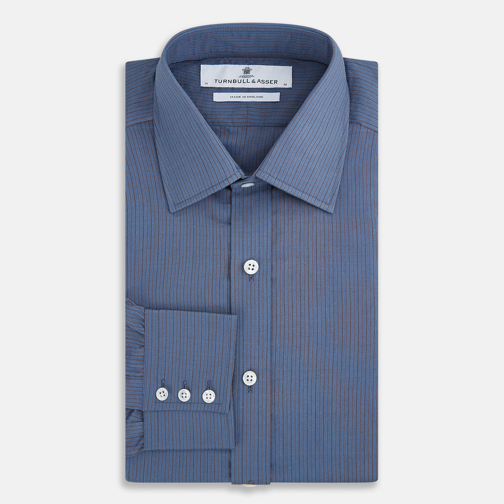 A neatly folded men's Mid Blue Red Stripe Regular Fit Mayfair Shirt by Turnbull & Asser, featuring long sleeves, classic collar, white buttons, and subtle red stripes—a hallmark of the brand’s renowned luxury.