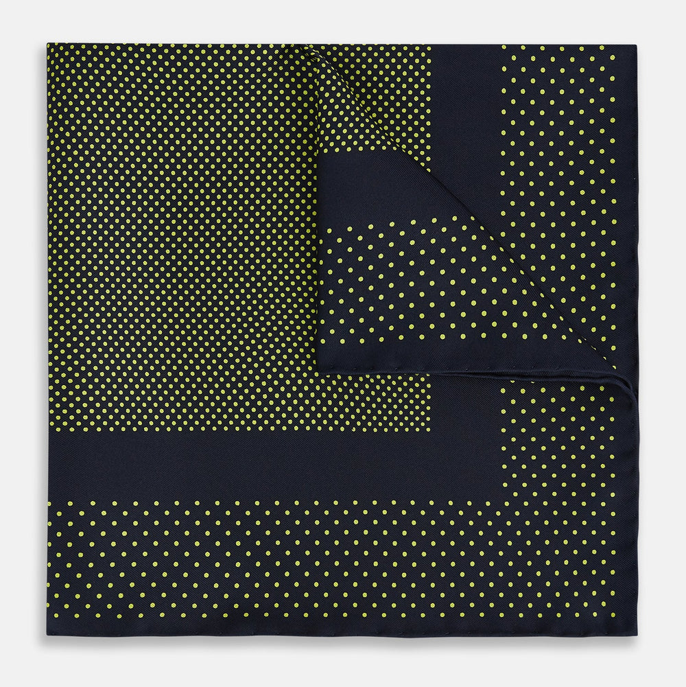 The Turnbull & Asser Navy and Yellow Dot Silk Pocket Square features a navy base with yellow dots, a solid navy border, and a folded corner showing the patterned underside for an elegant accent.