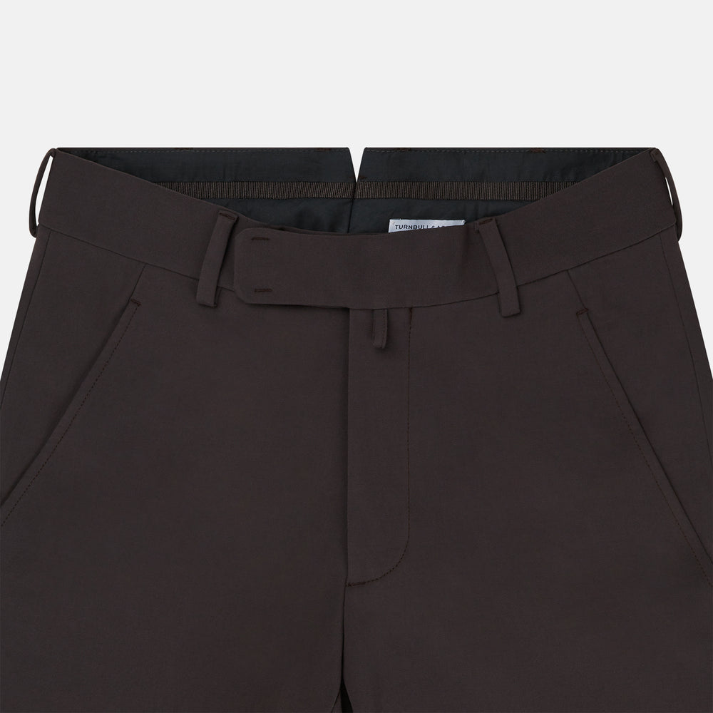 The Turnbull & Asser Brown James Trouser in a straight fit features Italian cotton, belt loops, side pockets, and a front zipper with button closure, displayed on a plain white background.