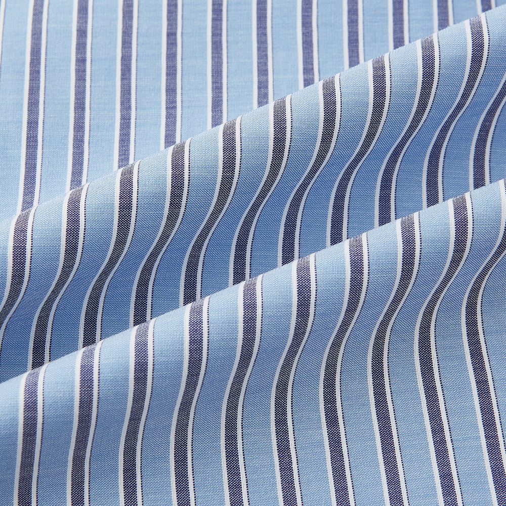 The Steel Blue Ticking Stripe Westminster Shirt by Turnbull & Asser features a classic fit, Turnbull collar, vertical stripes, white buttons, and buttoned cuffs—showcasing refined British craftsmanship.