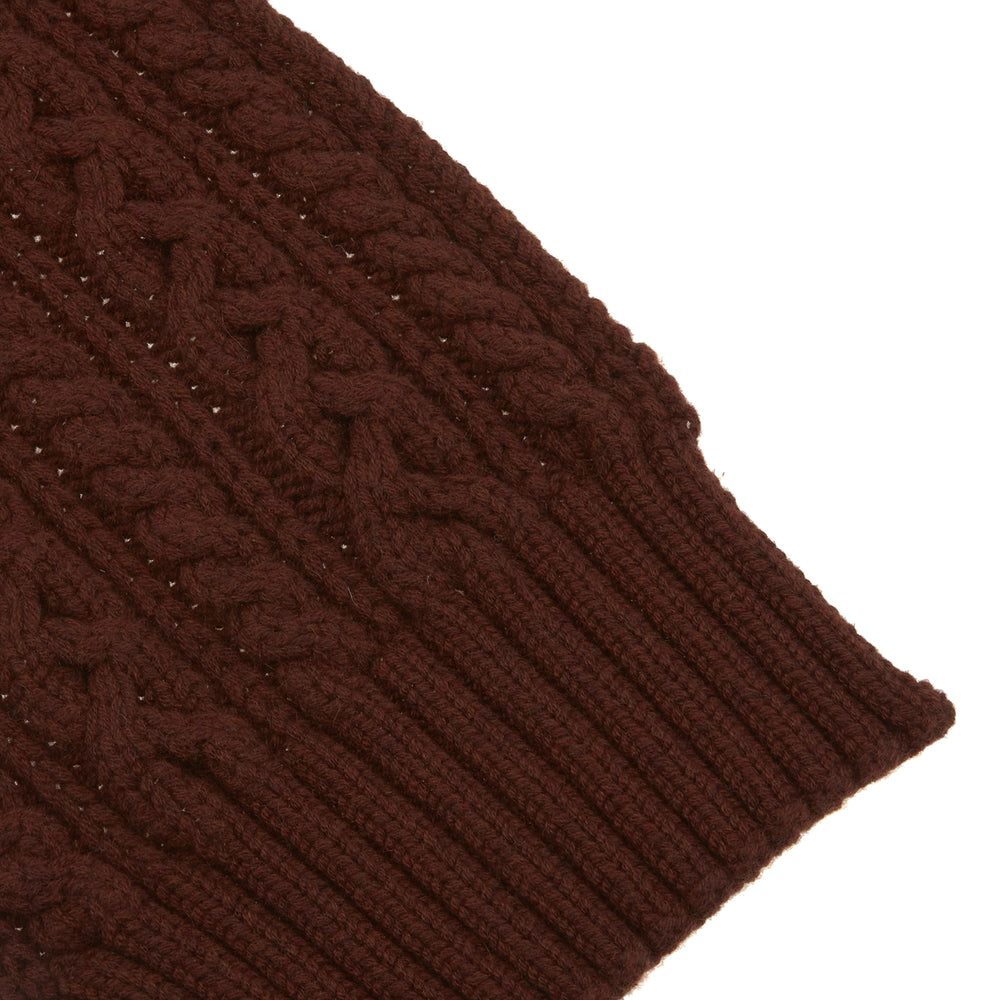 The Turnbull & Asser Red Grouse Cable Knit Cashmere Scarf, featuring ribbed ends, is neatly folded against a white background.