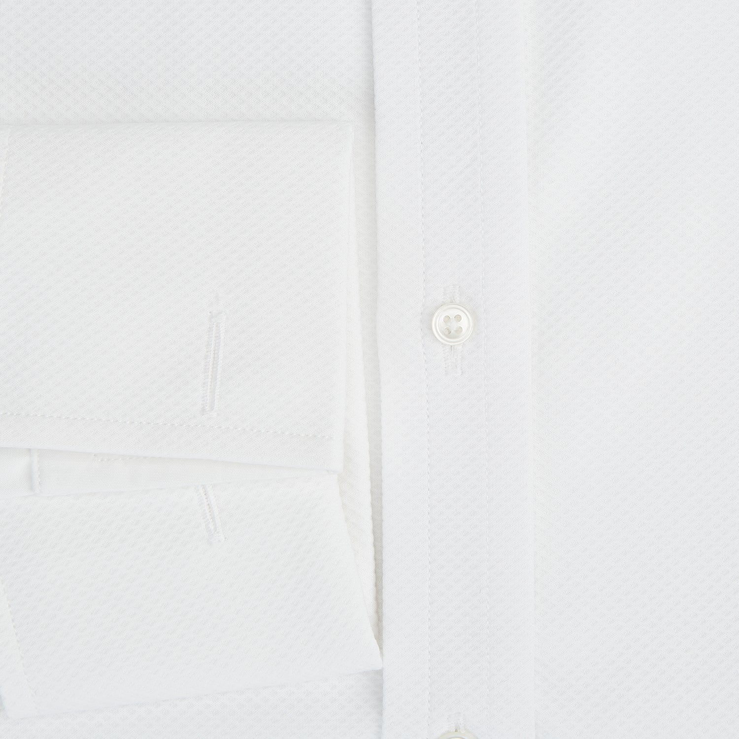 View 4 of product The Turnbull & Asser Tailored Fit White Marcella Front Shirt features a Kent Collar and double cuffs, shown laid flat on a white background. Perfect as a black tie shirt for formal events.