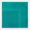 View 3 of product The Turnbull & Asser Petrol Green Dot Silk Pocket Square, made in England, features a border and small black polka dots, neatly folded to showcase both front and back sides.