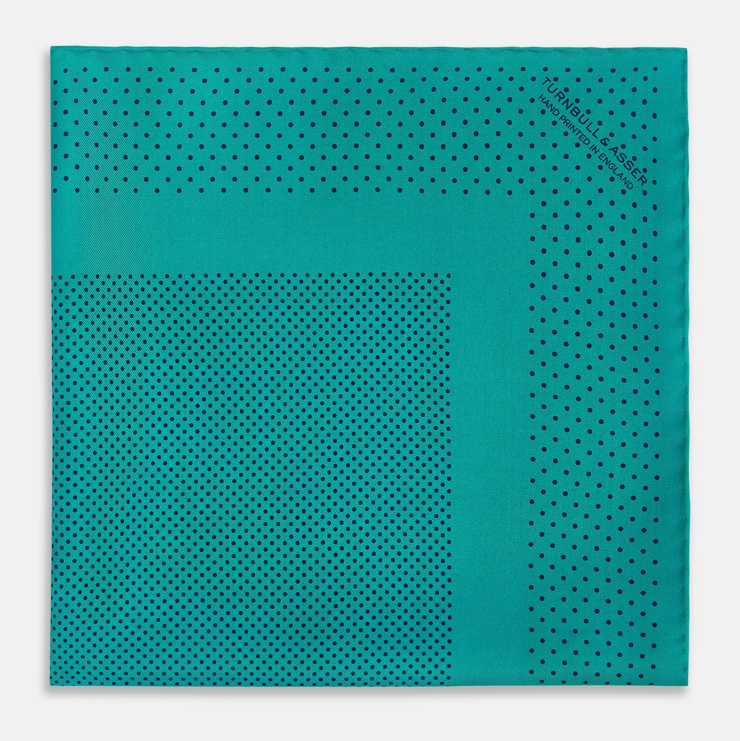 View 3 of product The Turnbull & Asser Petrol Green Dot Silk Pocket Square, made in England, features a border and small black polka dots, neatly folded to showcase both front and back sides.