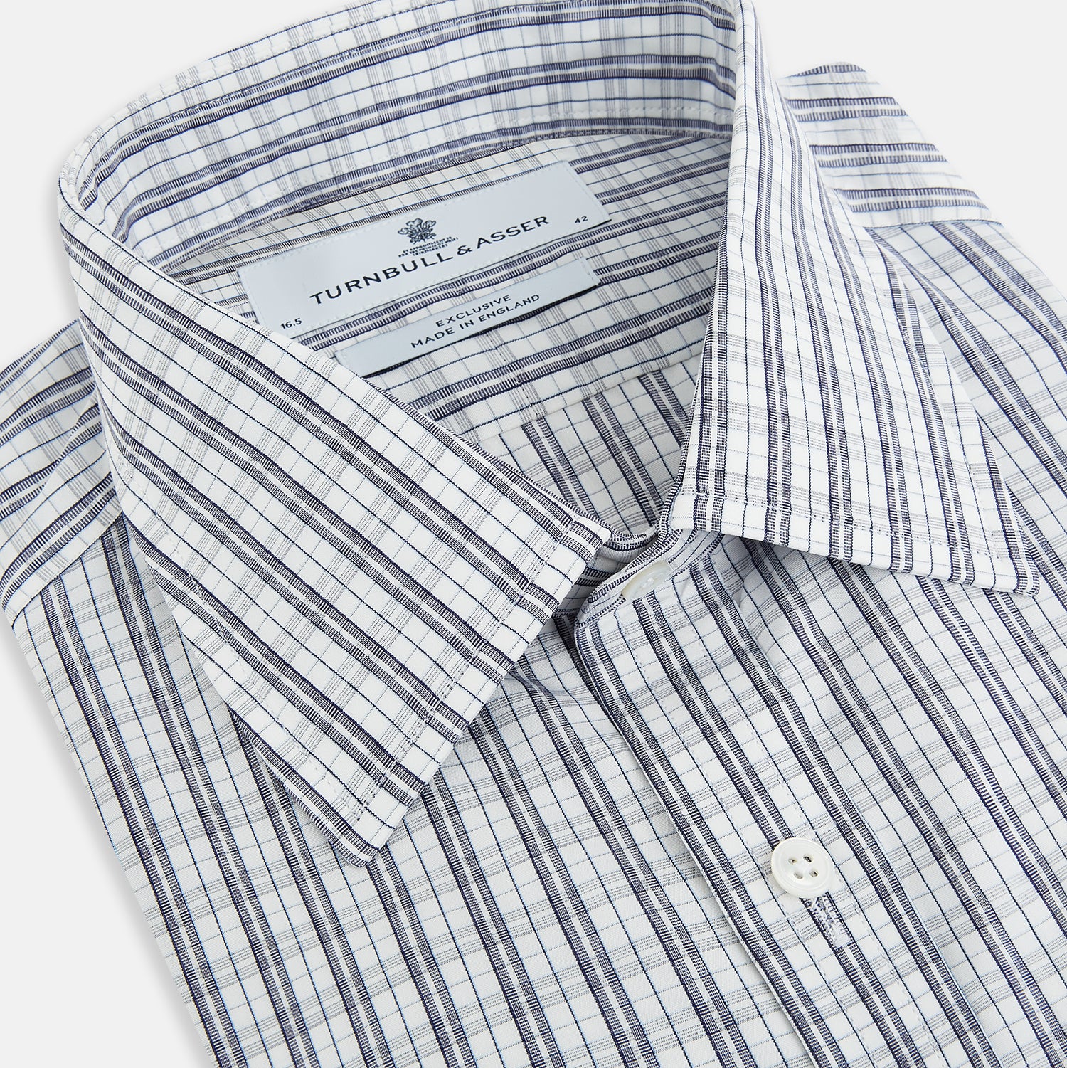 View 2 of product The Turnbull & Asser Navy Multi Check Mayfair Shirt is made from pure cotton with a blue and white check pattern, long sleeves, pointed collar, and buttoned cuffs, shown against a white background.