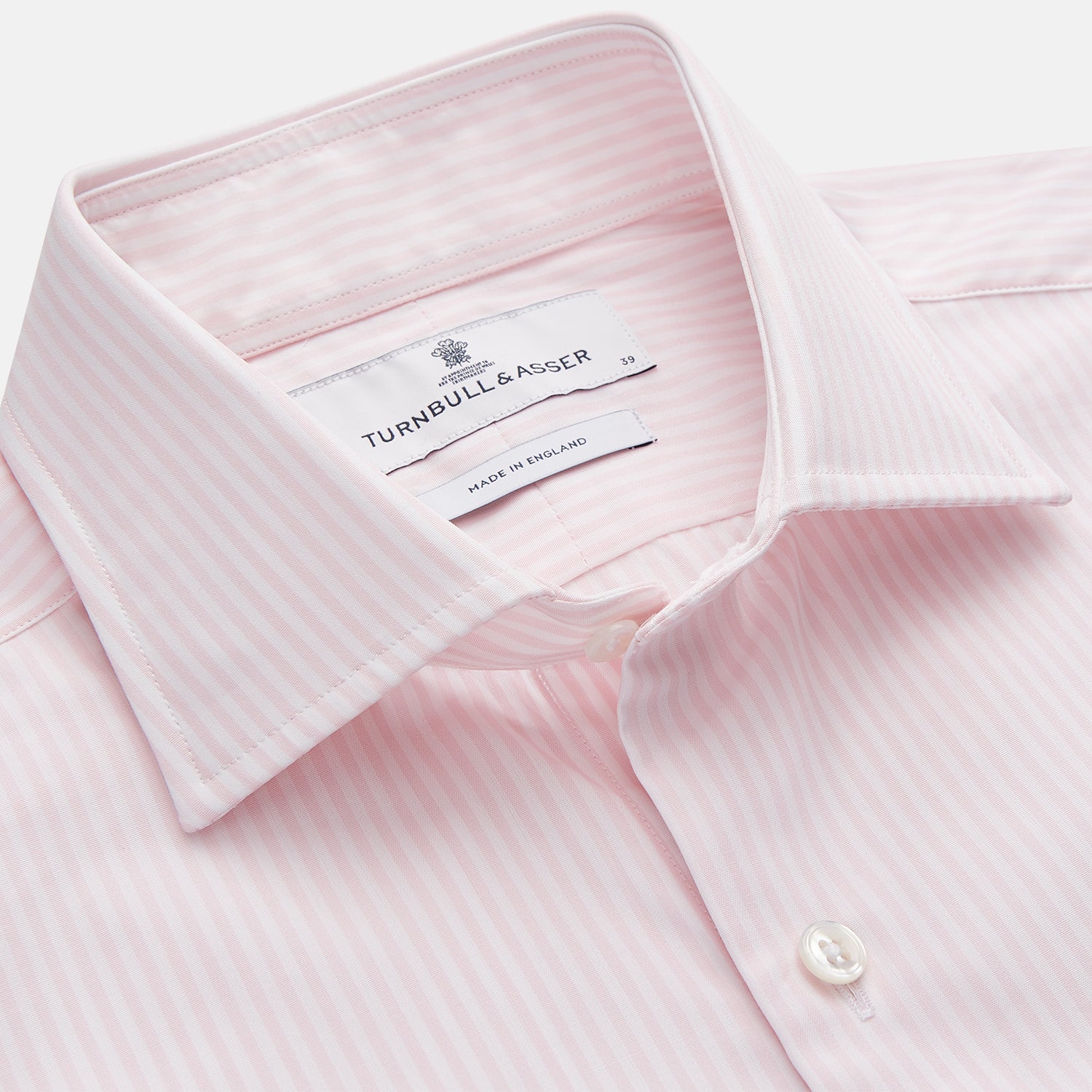 View 2 of product The Turnbull & Asser White and Pink Wide Stripe Belgravia Shirt features long sleeves, a classic collar, buttoned cuffs, and a wide stripe pattern—an elegant men's formal shirt from the Belgravia collection.