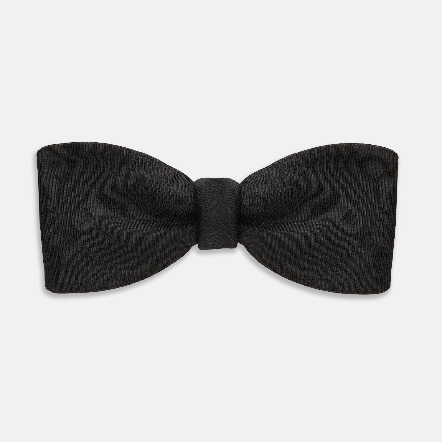 Image 1 of product The Casino Royale Bow Tie by Turnbull & Asser, as seen on James Bond, is a classic black Shantung silk bow tie with a smooth, slightly shiny finish, shown against a plain white background.