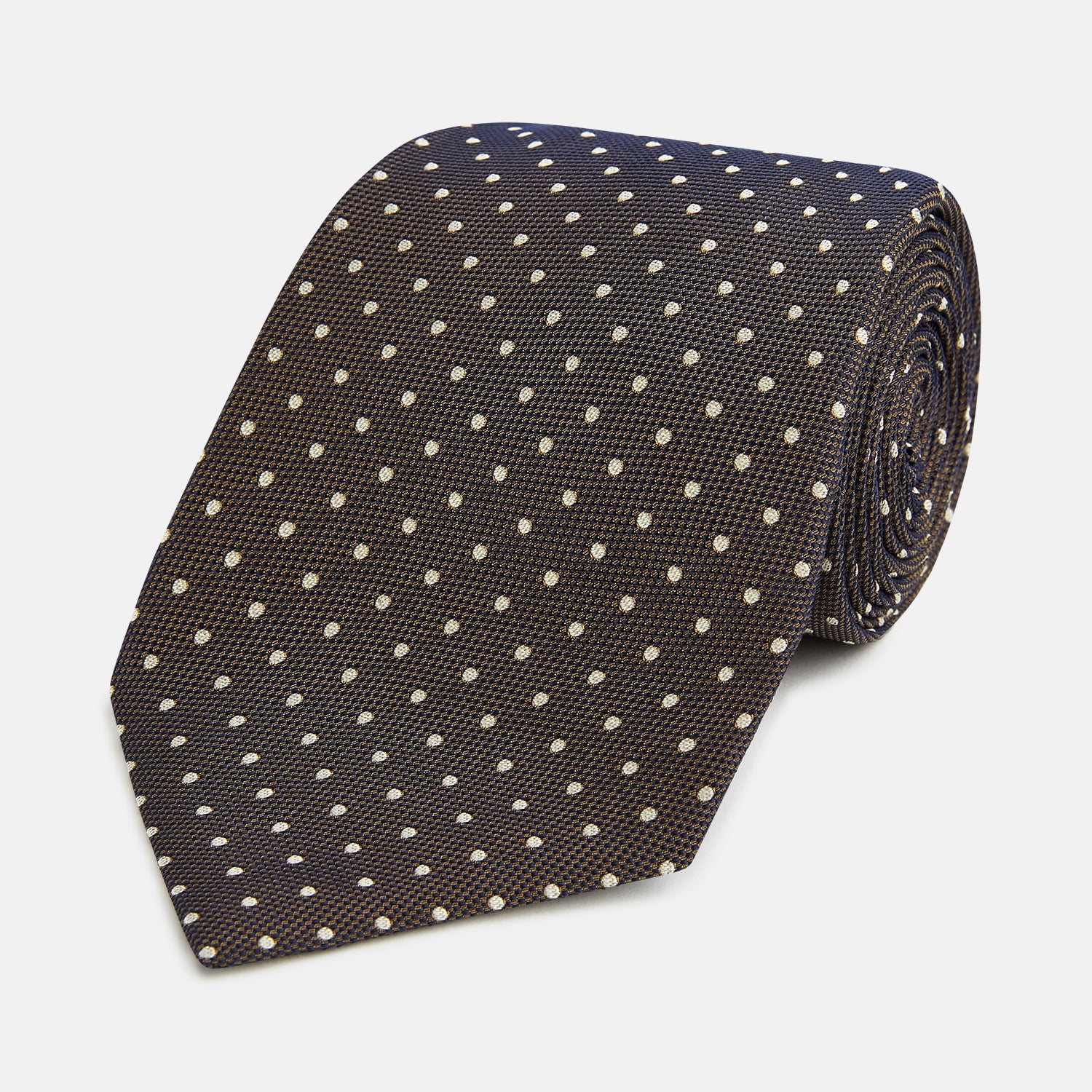 View 1 of product The Turnbull & Asser White and Brown Micro Dot Silk Tie features a refined micro dot pattern—an essential accessory for any men's wardrobe.