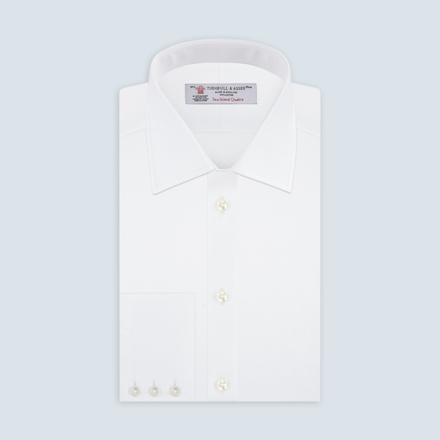 View 2 of product Close-up of Turnbull & Asser’s White Herringbone Sea Island Quality Cotton Fabric, showing a circular white textured surface with a subtle herringbone pattern and gray border on a plain white background.