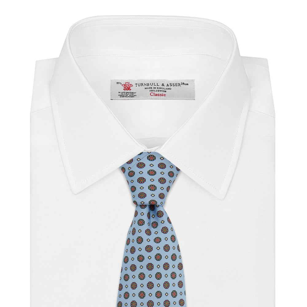 The Great Gatsby Silk Tie by Turnbull & Asser, as seen on Jay Gatsby—a light blue silk tie with red, yellow, and navy geometric floral motifs, ideal for classic 1920s-inspired shirts.