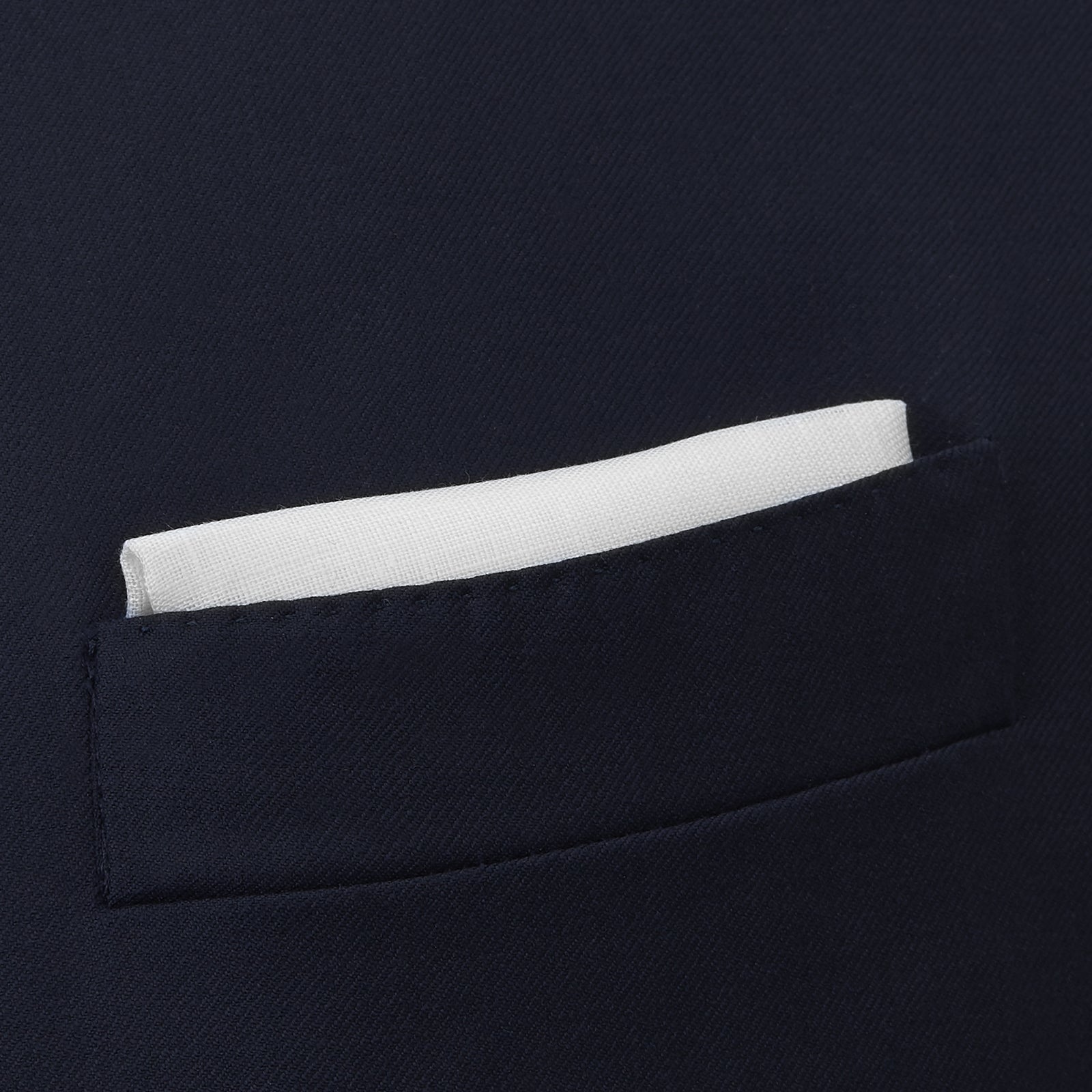 View 4 of product The Turnbull & Asser White Linen Handkerchief, elegantly folded with a corner turned down, evokes classic evening jacket style and is shown against a plain white background.