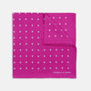View 1 of product The Fuchsia Spot Silk Pocket Square by Turnbull & Asser features bright fuchsia silk with evenly spaced white spots and the brand’s name in one corner. A classic accessory, it is shown with one corner folded over.
