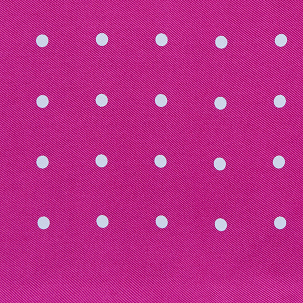 The Fuchsia Spot Silk Pocket Square by Turnbull & Asser features bright fuchsia silk with evenly spaced white spots and the brand’s name in one corner. A classic accessory, it is shown with one corner folded over.