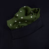 View 4 of product The Turnbull & Asser Olive Spot Silk Pocket Square features white polka dots, the brand’s logo in one corner, and a stylishly folded tip for a dapper finish.