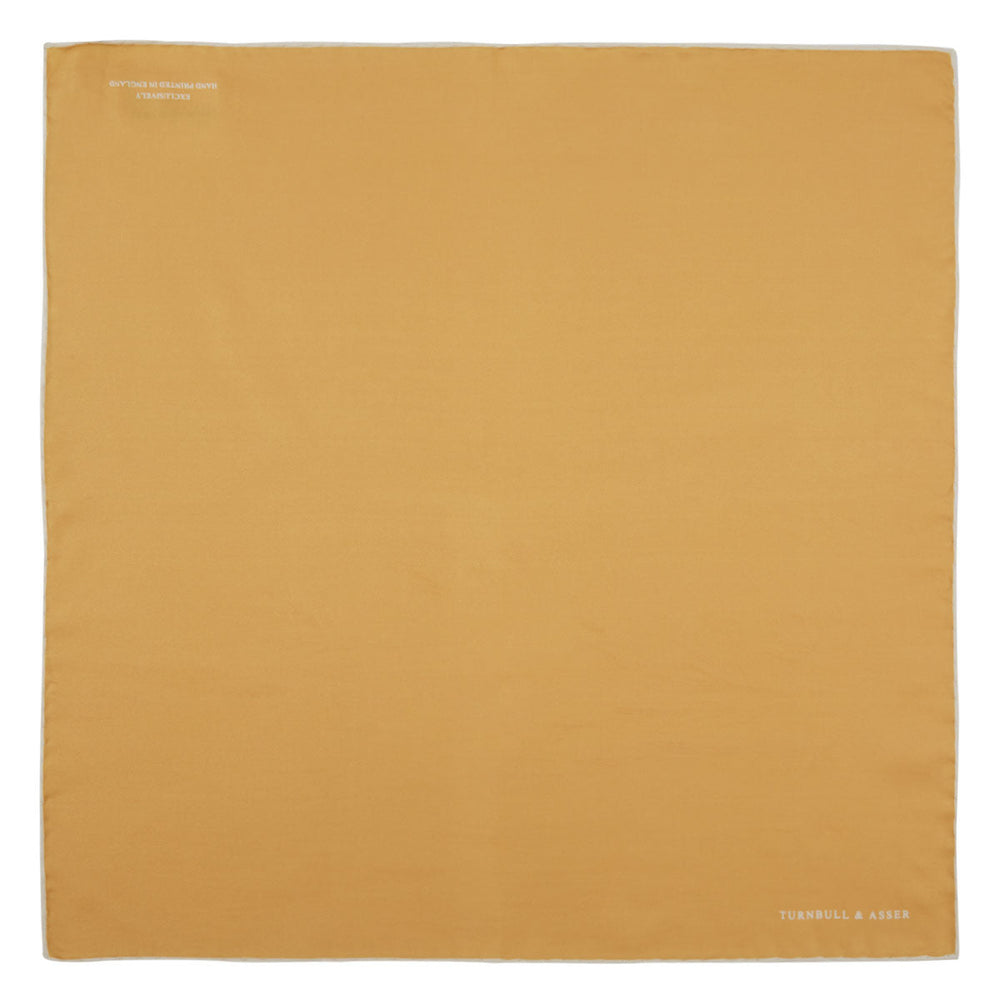 The Gold and White Piped Silk Pocket Square by Turnbull & Asser features neat white edging and TURNBULL & ASSER printed in one corner—a timeless silk accessory for any wardrobe.