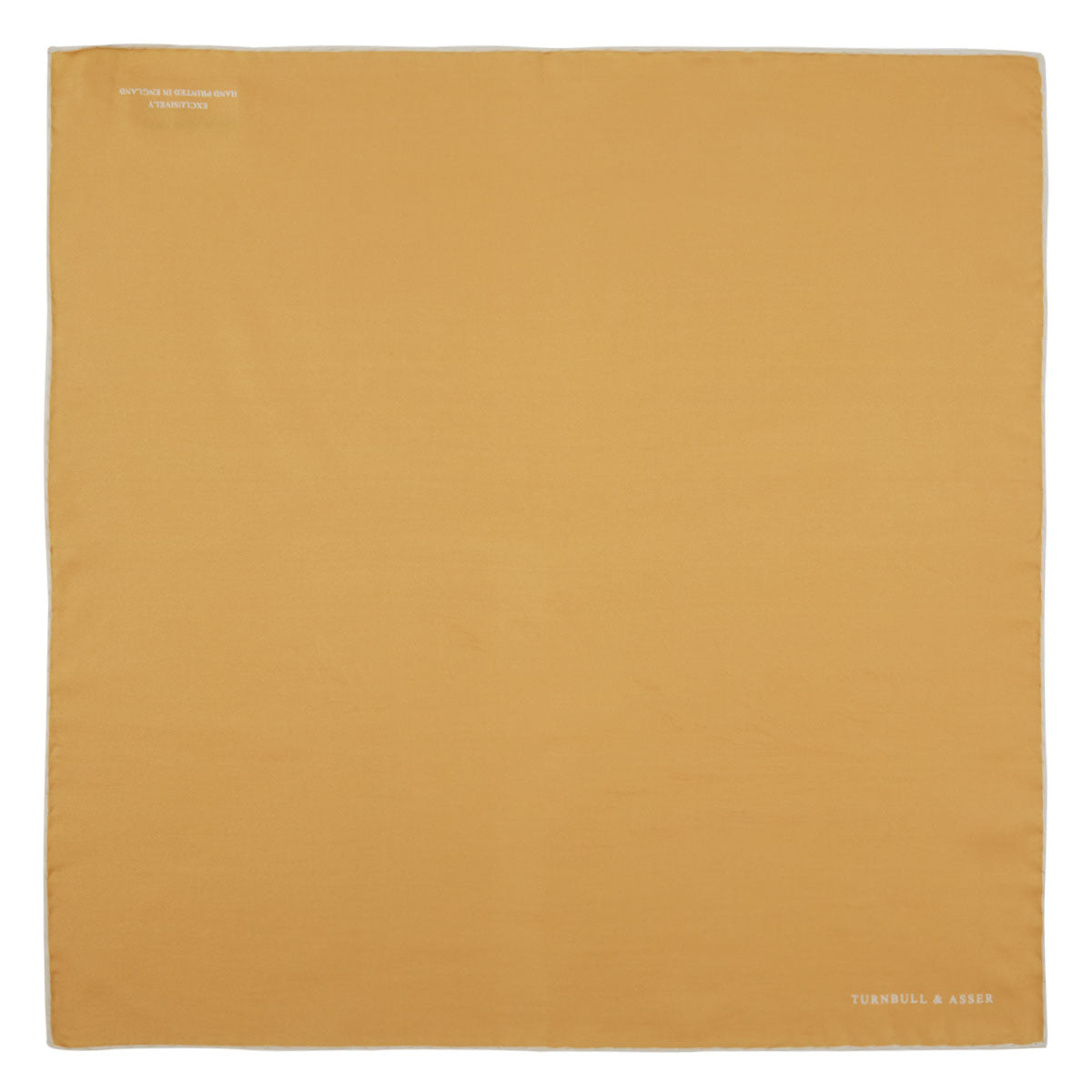 View 2 of product The Gold and White Piped Silk Pocket Square by Turnbull & Asser features neat white edging and TURNBULL & ASSER printed in one corner—a timeless silk accessory for any wardrobe.