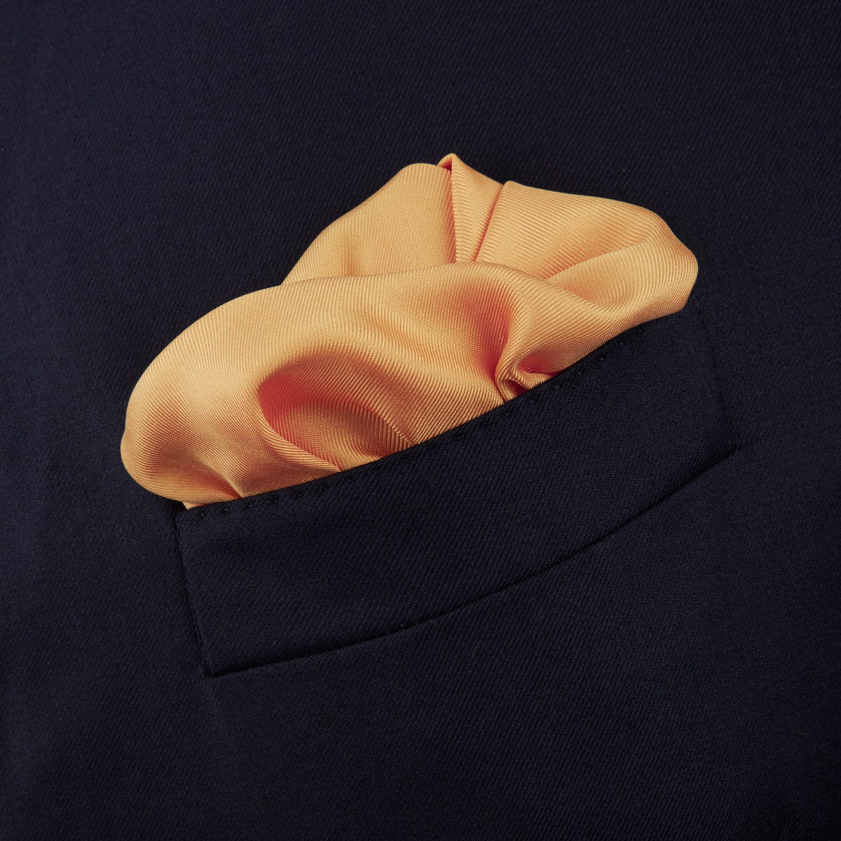 View 4 of product The Gold and White Piped Silk Pocket Square by Turnbull & Asser features neat white edging and TURNBULL & ASSER printed in one corner—a timeless silk accessory for any wardrobe.