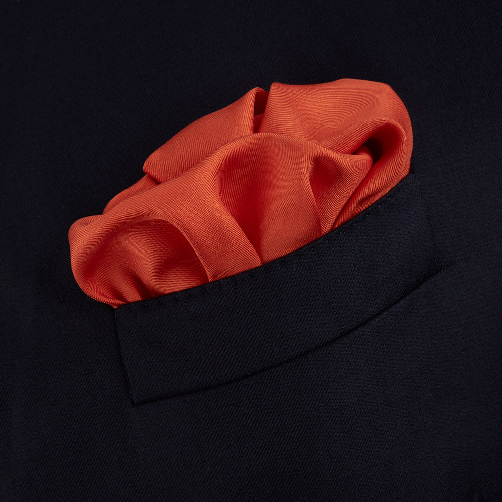 A classic men's accessory, the Turnbull & Asser Dark Orange and White Piped Silk Pocket Square adds a timeless touch to any look.