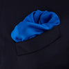 View 4 of product The Royal Blue Piped Silk Pocket Square by Turnbull & Asser features a vibrant blue hue, subtle stitched border, and the brand name printed in white in the lower right corner.