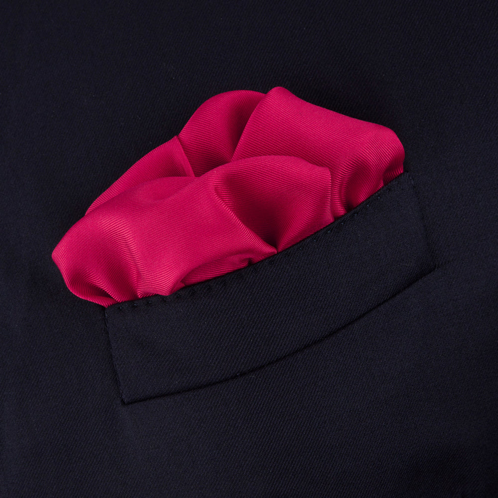 A classic accessory, the Turnbull & Asser Red and White Piped Silk Pocket Square is neatly folded to showcase both colors, with the brand’s logo in white on the corner.