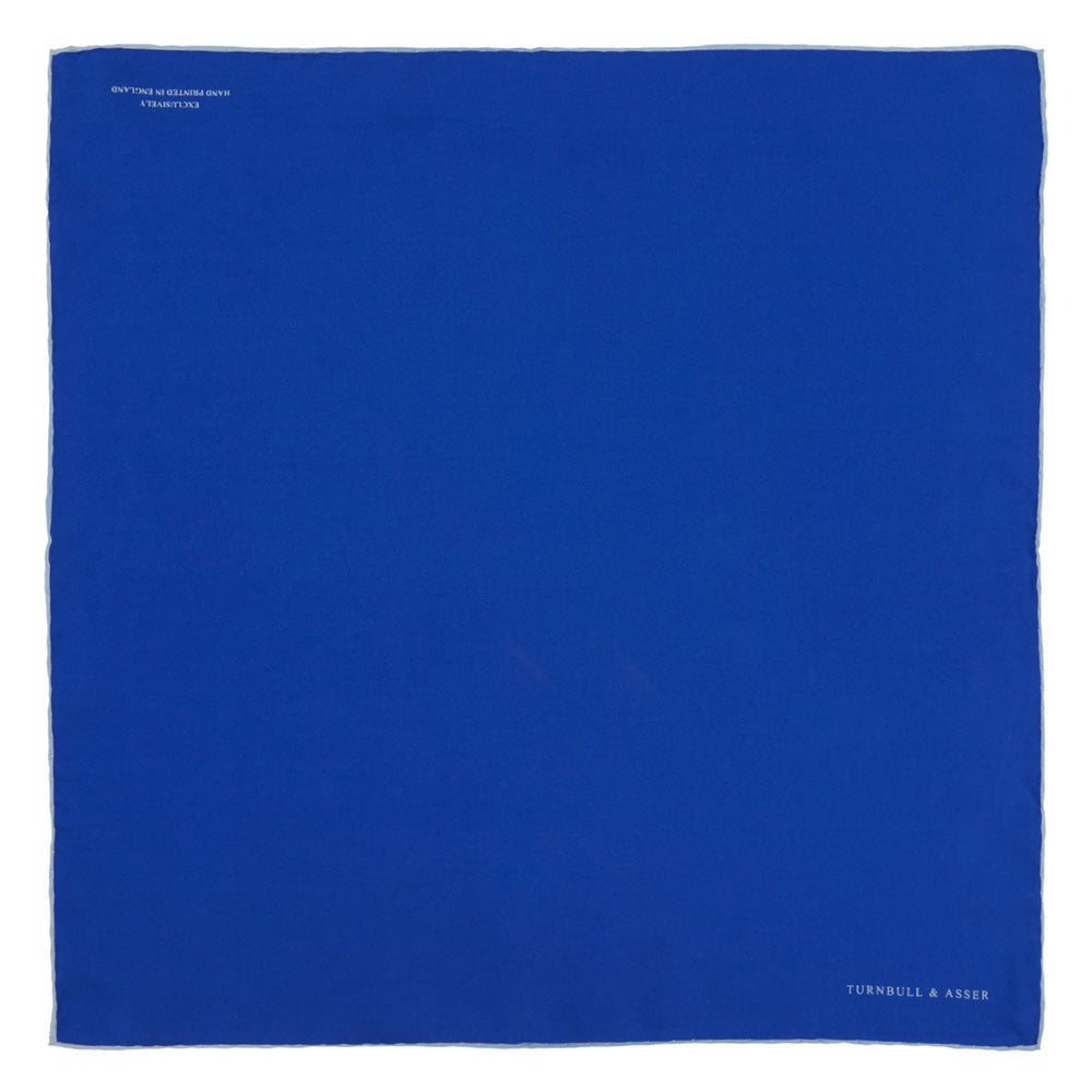 A Dark Blue Piped Silk Pocket Square by Turnbull & Asser, neatly folded with white edging and the brand's logo in one corner, displayed on a plain white background.