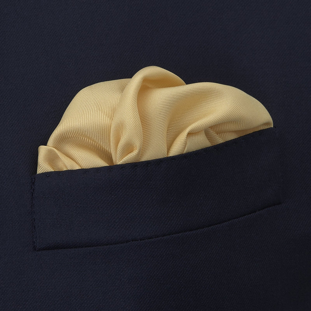 The Yellow and Navy Piped Silk Pocket Square by Turnbull & Asser features blue piping and the brand’s logo in blue on yellow silk—an elegant accessory for any outfit.