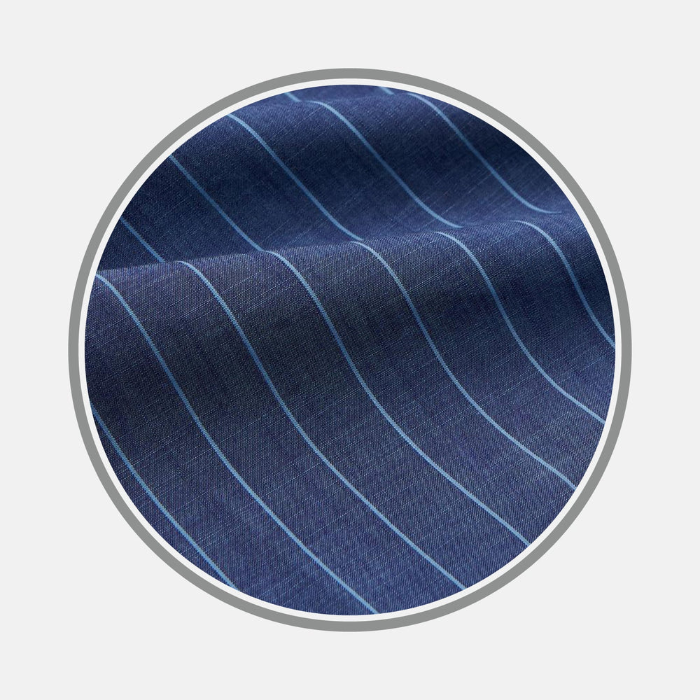 A close-up of Turnbull & Asser's BESPOKE FABRIC 1227 32: blue cloth with thin, even white stripes, ideal for custom shirts—displayed in a circular frame on a light gray background.