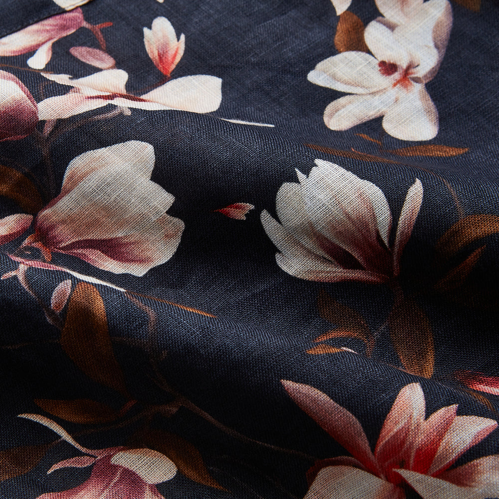The Turnbull & Asser Navy Floral Pattern Linen Hayhurt Kimono Gown is a knee-length, long-sleeved gown with a floral print and a matching fabric belt tied at the waist.