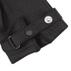View 2 of product Turnbull & Asser Black Kirkdale Leather Gloves, featuring textured black leather and a sleek wrist strap with a small buckle detail, are displayed on a white background.