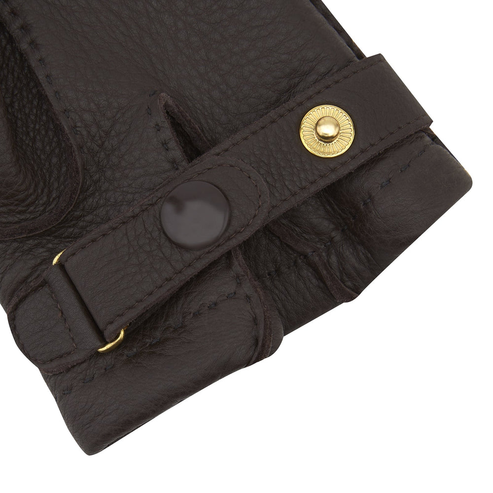 Turnbull & Asser Dark Brown Kirkdale Leather Gloves, shown on a white background, feature a textured leather finish, decorative stitching on the back, and an adjustable wrist strap.