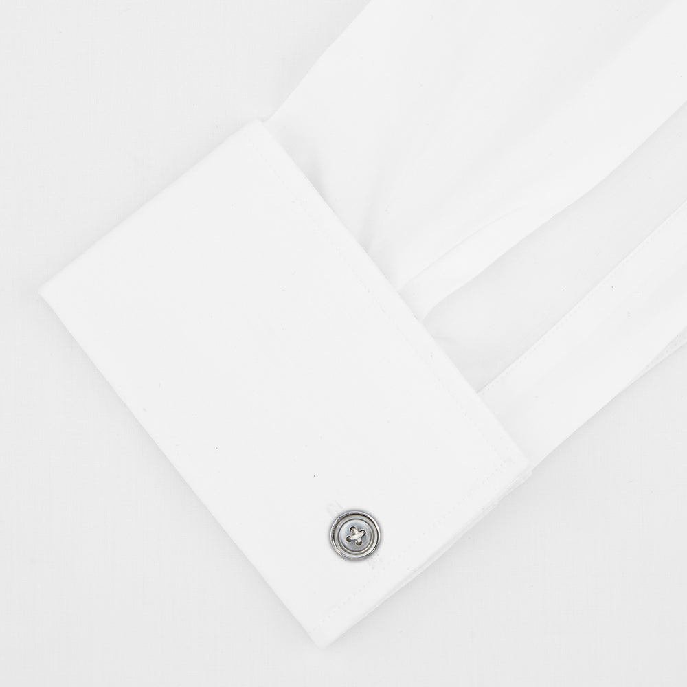 The Tailored Fit White Pleated Front Shirt with Kent Collar and Double Cuffs by Turnbull & Asser is neatly folded and buttoned up, shown on a light grey background—a classic black tie shirt option.