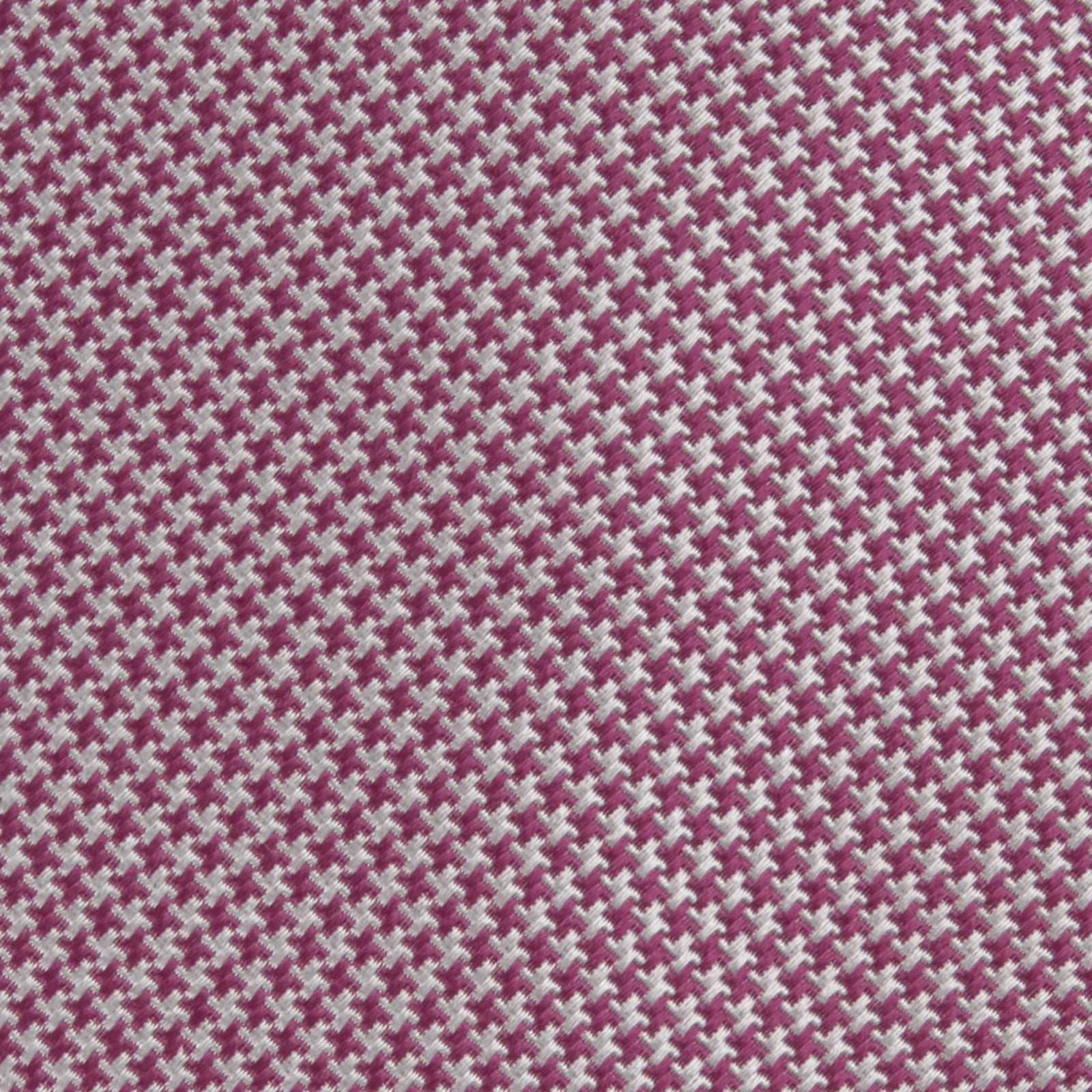 View 3 of product The Turnbull & Asser Dark Pink Houndstooth Silk Tie is rolled up and displayed on a plain white background.