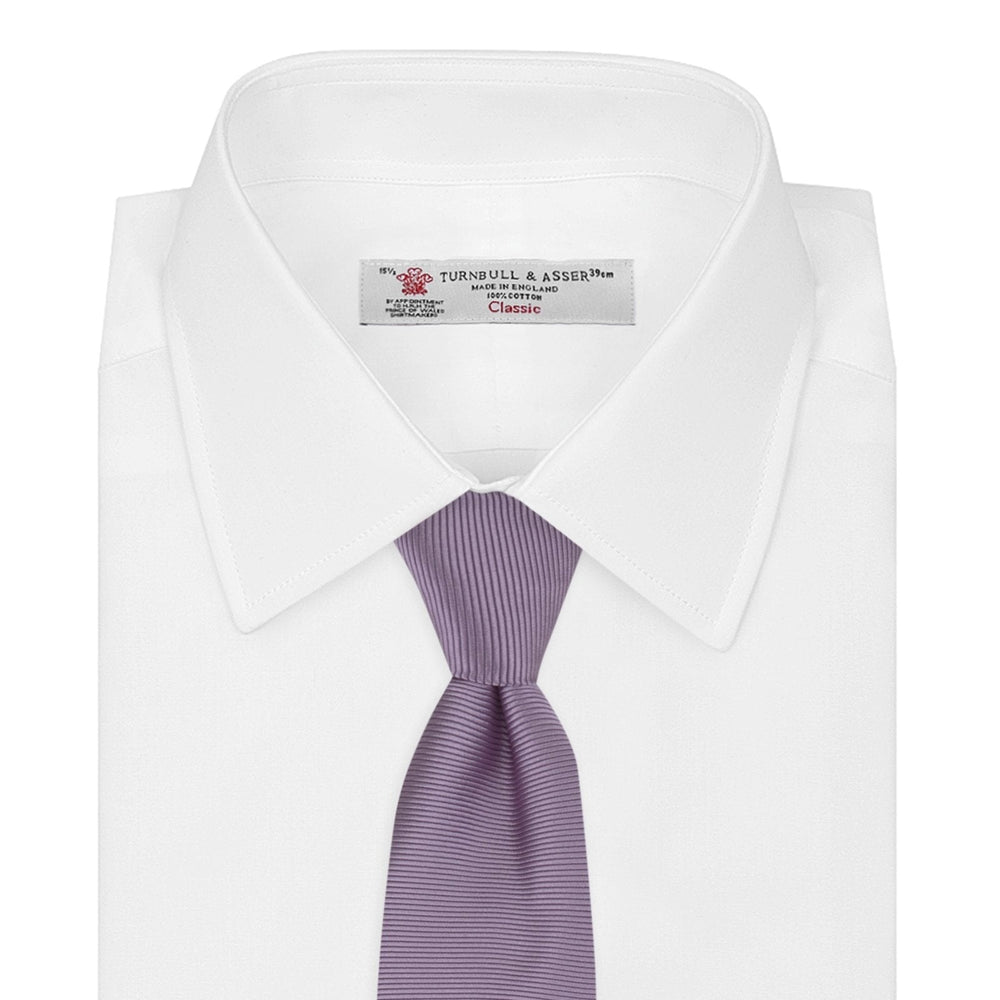The Lilac Horizontal Twill Silk Tie by Turnbull & Asser features a subtle ribbed texture and neat roll, shown on a white background—an ideal accessory for any cotton shirt.
