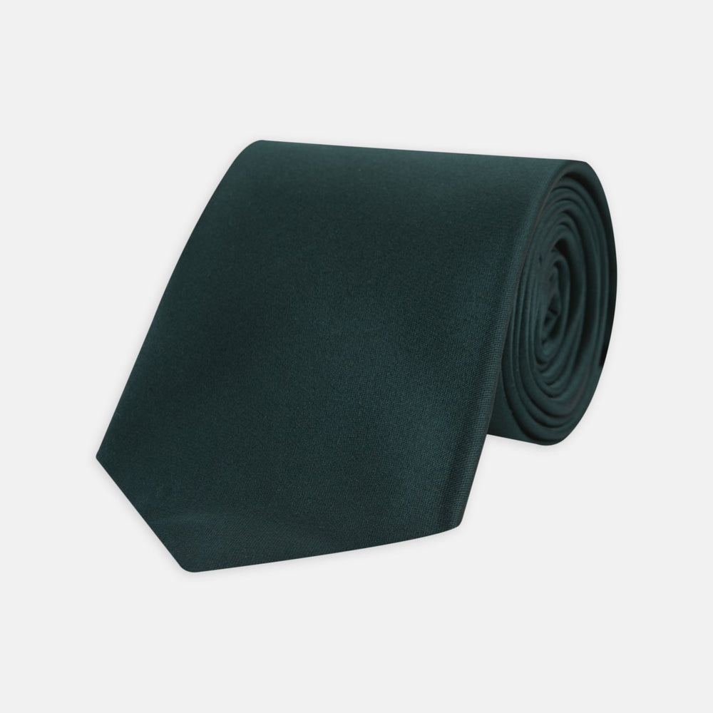 The Turnbull & Asser Forest Green Plain Satin Silk Tie, neatly rolled with a pointed end, is displayed on a plain white background.