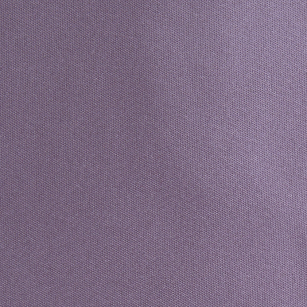 The Turnbull & Asser Lilac Plain Satin Silk Tie, featuring a smooth finish, is neatly rolled and displayed on a white background—a classic accessory for any versatile wardrobe.