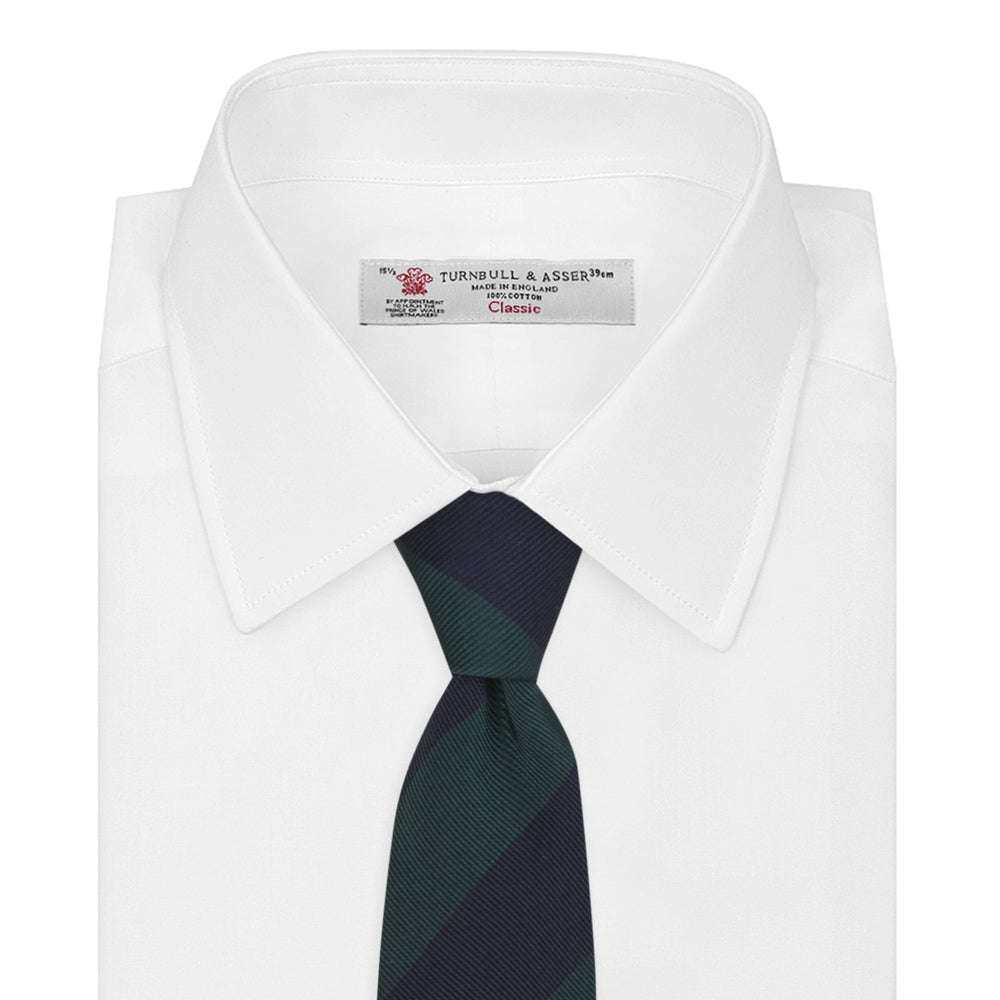 The Turnbull & Asser Navy and Forest Green Block Stripe Repp Silk Tie features bold stripes and is expertly crafted from luxurious silk, shown rolled on a white background.