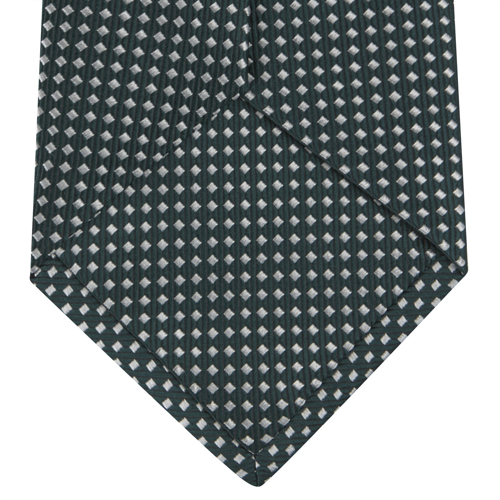 View 4 of product The Turnbull & Asser Forest Green and White Diamond Silk Tie features a geometric pattern of small, evenly spaced white diamonds on a forest green background, displayed rolled up on a white surface.
