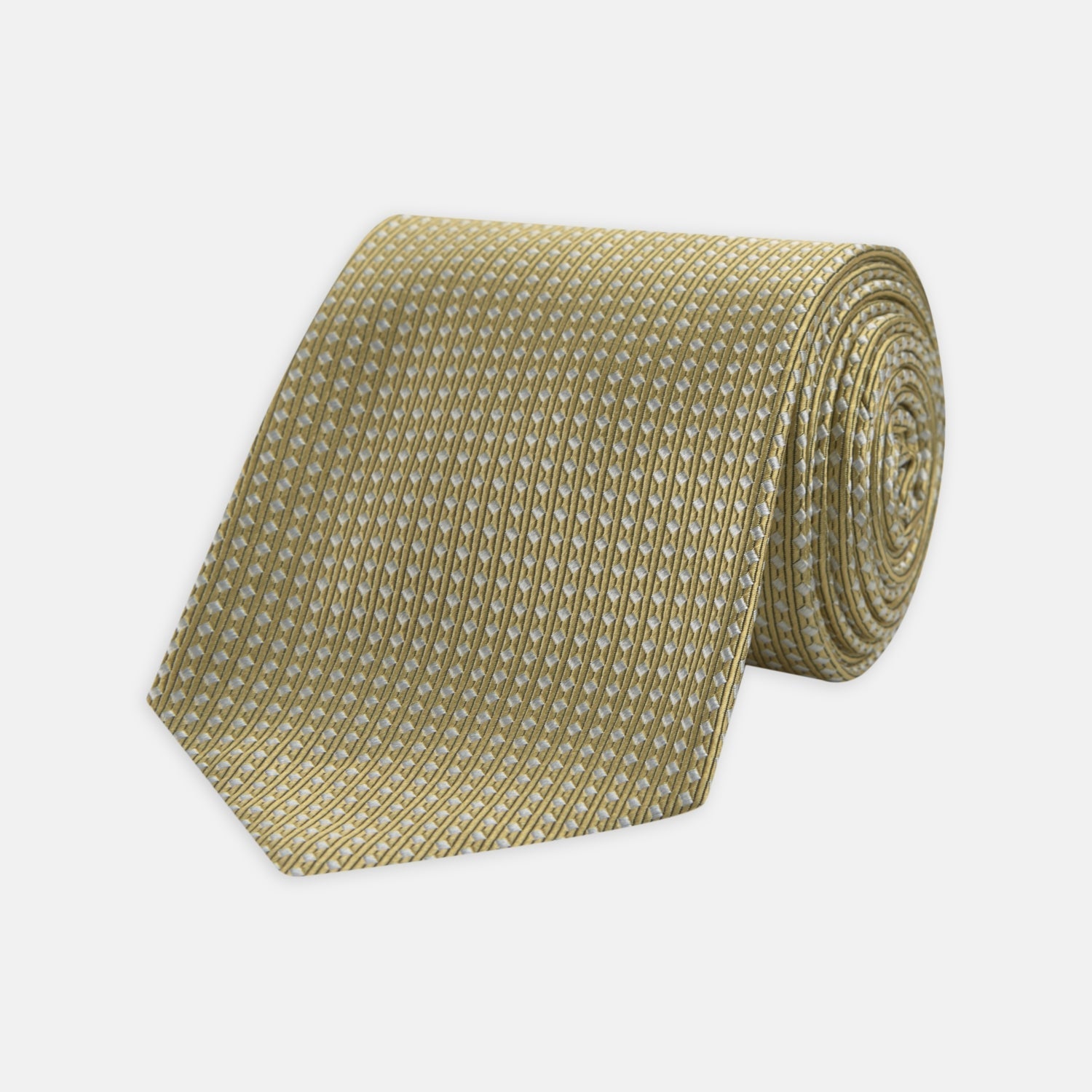 View 1 of product The Gold and White Diamond Silk Tie by Turnbull & Asser features a classic textured diagonal diamond pattern—ideal for elevating your favorite office shirt.