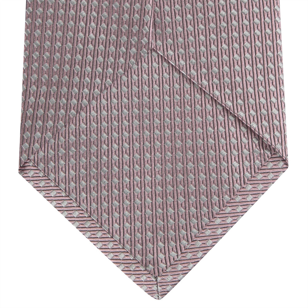 The Turnbull & Asser Rose and White Diamond Silk Tie, shown rolled on a white background, features a subtle diamond pattern—an elegant accessory to elevate any office shirt.