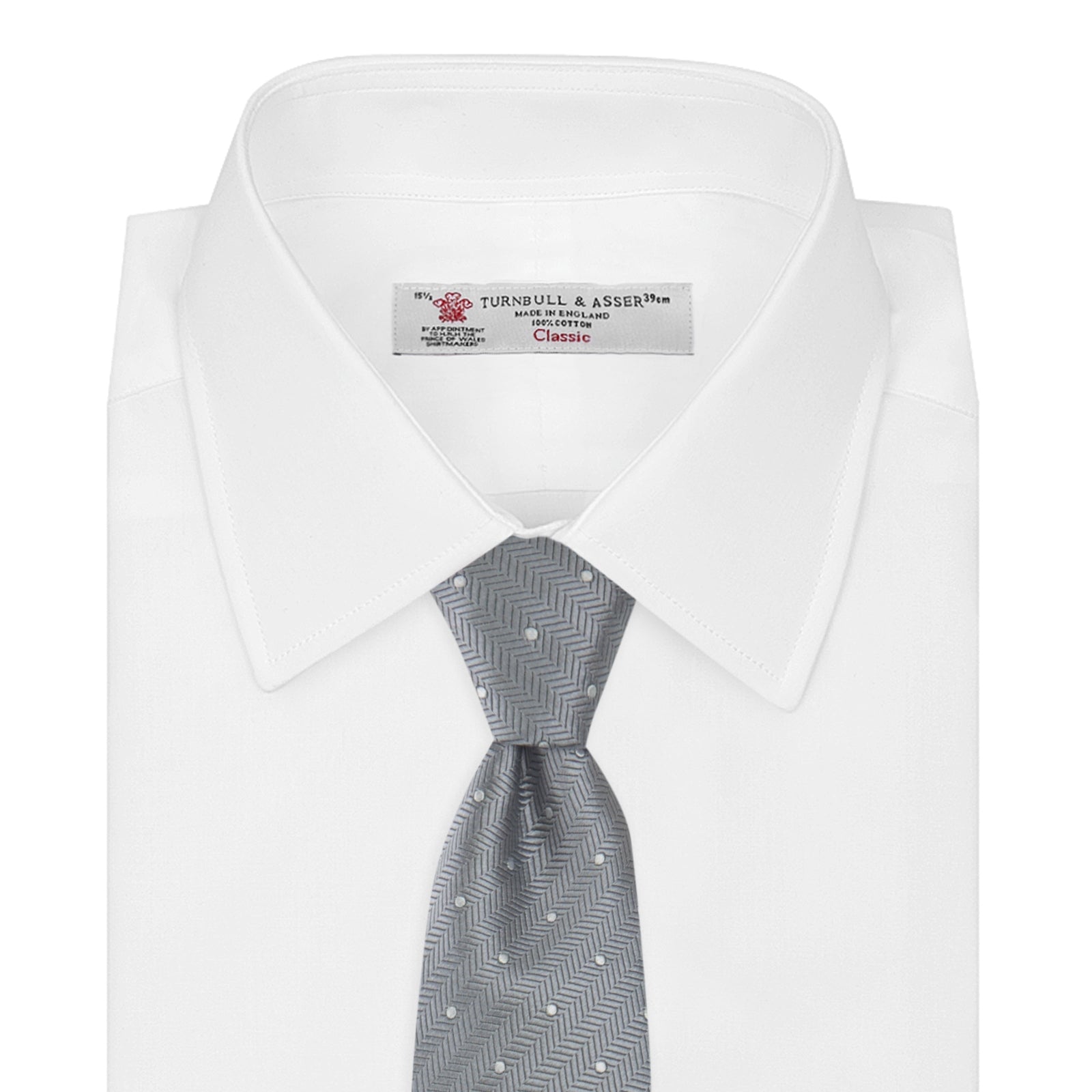 View 2 of product The Turnbull & Asser Grey and White Small Spot Herringbone Silk Tie, expertly woven from silk, is displayed rolled-up against a white background.