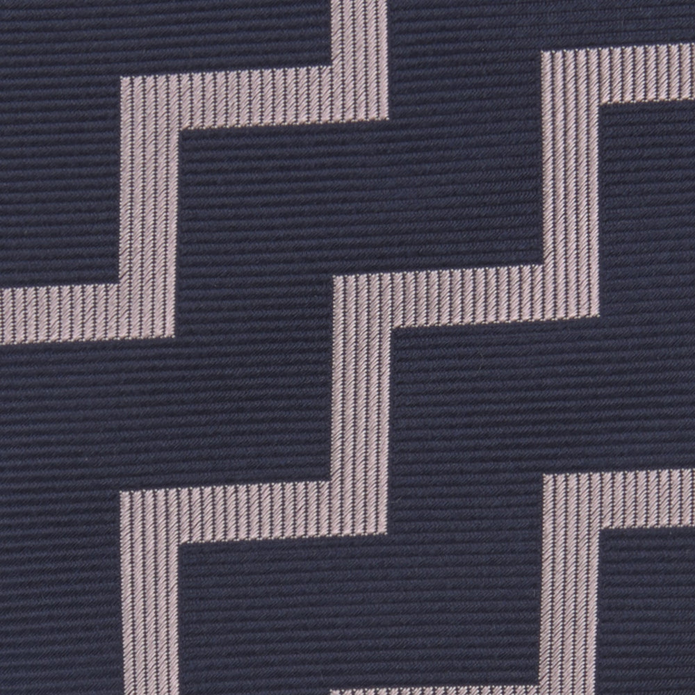 The Turnbull & Asser Navy and Rose Striped Zigzag Silk Tie features a bold zigzag pattern and is shown against a plain white background, making it an ideal accessory for the modern gentleman.