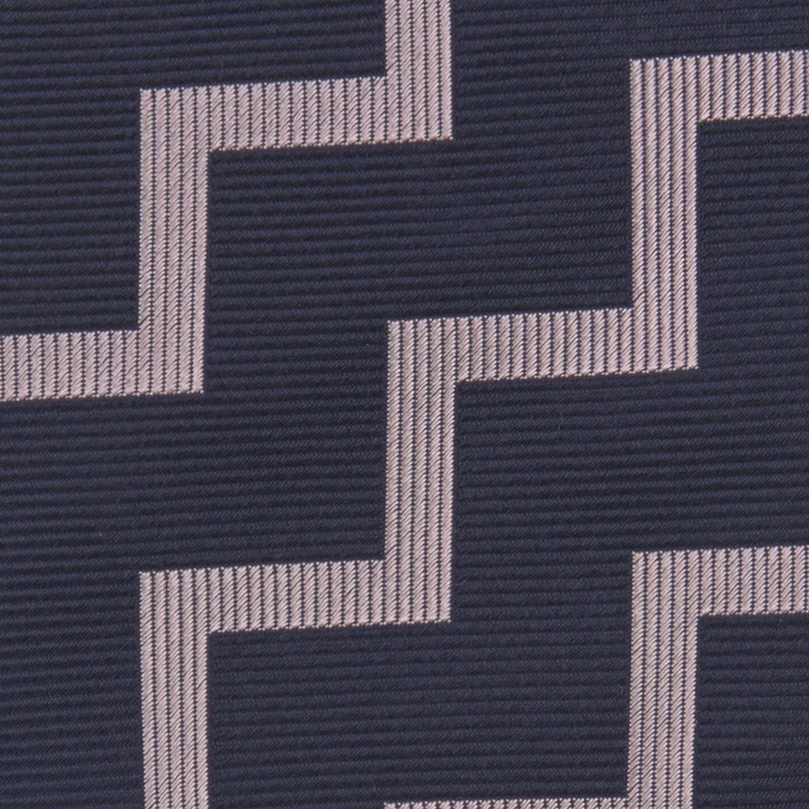 View 3 of product The Turnbull & Asser Navy and Rose Striped Zigzag Silk Tie features a bold zigzag pattern and is shown against a plain white background, making it an ideal accessory for the modern gentleman.